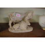 An alabaster figure group of a cow and calf, 23cm wide, (chips).