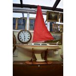 A large pond yacht, the hull 125.5cm long, on plywood stand.