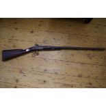 An antique percussion side by side muzzle loading black powder shotgun.