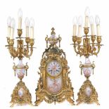 ORNATE BARCELONA CLOCK AND PAIR OF CANDELABRAS. FIRST DECADES C20thGilded bronze with porcelain