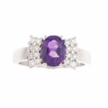 AMETHYST & DIAMOND RING.White gold with 1ct central oval cut amethyst with approx 0.47ct brilliant