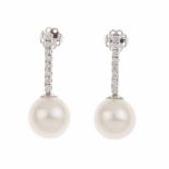 DIAMOND AND PEARL DROP EARRINGSWhite gold with brilliant cut diamonds set in a line; total weight