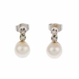 EARRINGS WITH TWO DIAMONDS AND A PEARL.White gold with an approx. 7cm diam pearl & two brillaint cut