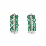 DIAMOND AND EMERALD EARRINGSWhite gold with oval cut emeralds in a double channel setting. T otal