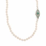 LONG PEARL NECKLACE.Pearls of 7mm & platinum clasp with 8/8 cut diamonds & trapeze cut emeralds &