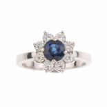 ROSETTE SAPPHIRE AND DIAMOND RINGWhite gold with 1.07ct central oval cut sapphire with bezel of