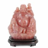 CHINESE SCHOOL, C20th LARGE SMILING BUDDHARose quartz with wooden pedestal. Slight imperfections.