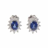 SAPPHIRE AND DIAMOND ROSETTE EARRINGS.White gold with 2.14ct oval cut sapphire with bezel of