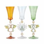 THREE VENETIAN GLASSES, C20thTransluscent glass. Floral decoration on stems. Height 29cm.- - -18.