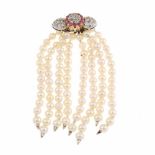 BROOCH WITH STRINGS OF HANGING PEARLS.White & yellow gold with 8/8 cut diamonds of 0.22ct & twelve
