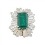 DIAMOND AND EMERALD ROSETTE RING. C20th.Platinum with trapeze cut diamonds, total weight approx. 4.