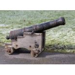 Militaria: A small cast iron cannon 19th century on later wooden carriage barrel 87cm long