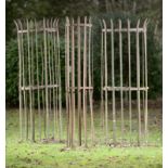 Garden: A pair of wrought iron tree guards late 19th/early 20th century 190cm high, together with