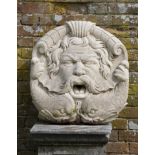 Water Features: A carved limestone fountain mask of a bearded man and dolphinslate 20th centurymouth