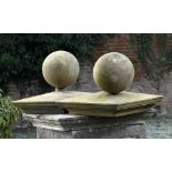Architectural: A pair of carved stone gate pier balls and capslate 19th centuryballs 30cm