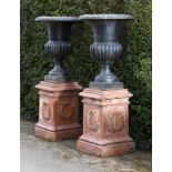 Planters/Pots: ‡ A pair of cast iron urnsmodern78cm high, on late Victorian terracotta