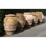 Planters/Pots: ‡ A set of three terracotta storage jars2nd half 20th centuryeach with similar