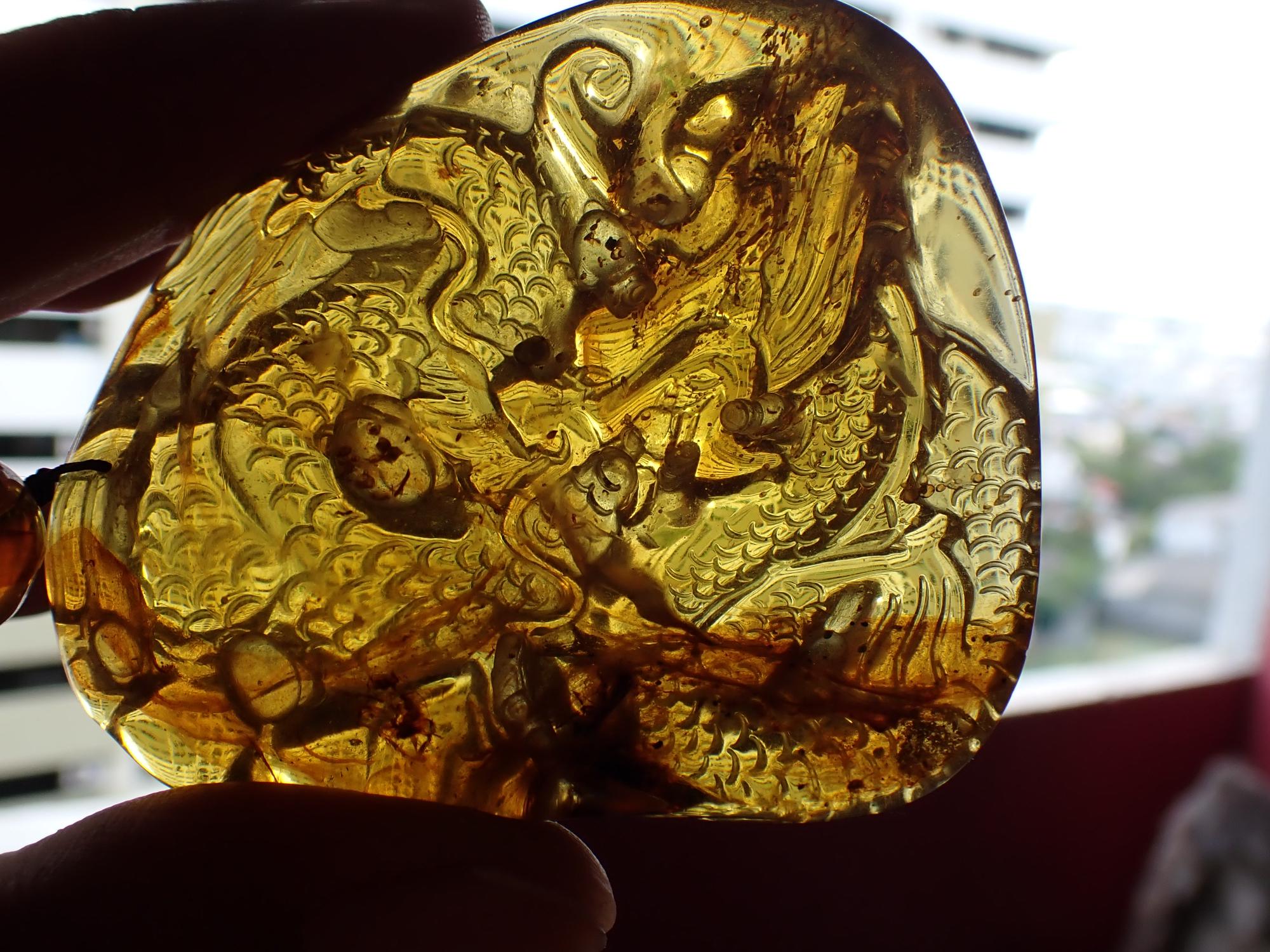 Natural History: An amber specimen, now carved and mounted as a pendant