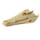 Natural History: A Nile crocodile skull, Madagascar, on metal stand, 39cm high by 17cm wide