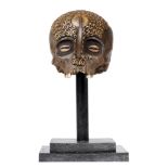 Ethnographica: A Dayak tribe human skull on stand, 35cm high overall