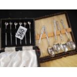 Silver cocktail sticks and plated spoons