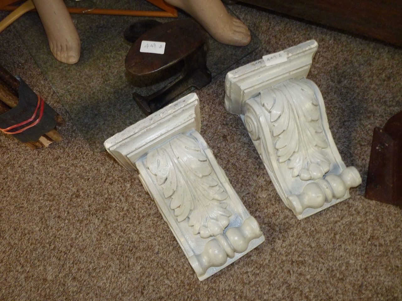 Pair of plaster corbels and a shoe last