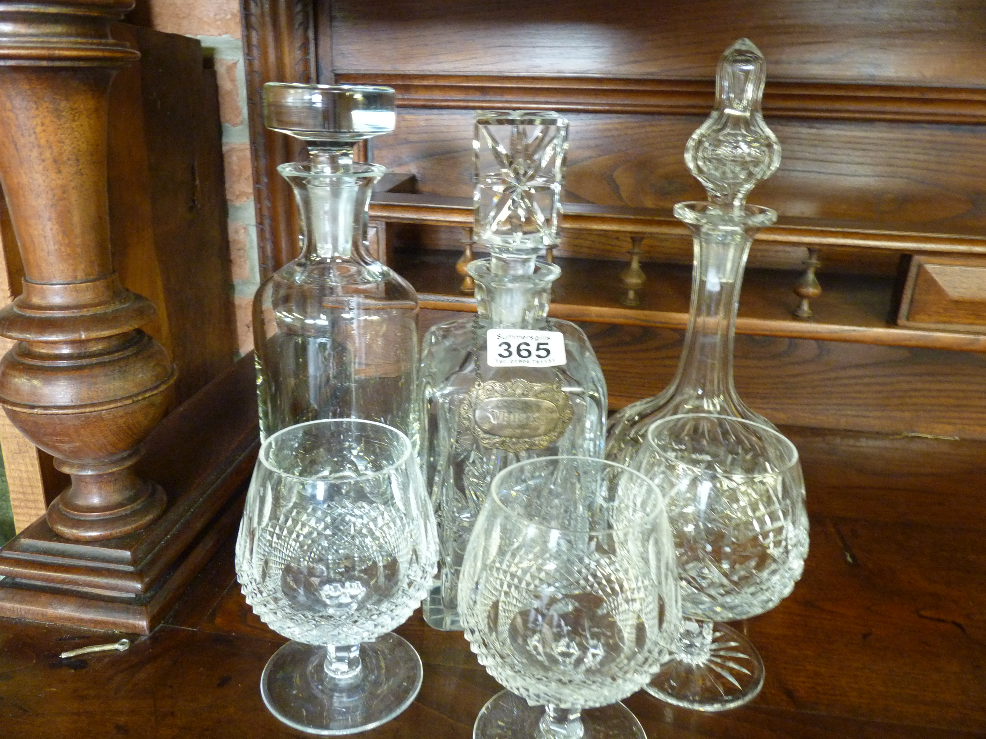 3 decanters and 3 brandy glasses