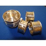 Silver napkin rings and a miniature cup