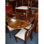 Regency style mahogany extending dining table and chairs