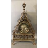 A BRUCE TALBERT DESIGN GOTHIC REVIVAL BRASS MANTLE CLOCK The engraved silvered dial with striking
