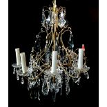 A DECORATIVE LATE 19TH/EARLY 20TH CENTURY GILT METAL EIGHT BRANCH CHANDELIER Hung with clear and