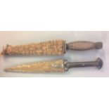 TWO LATE 19TH/EARLY 20TH CENTURY AFRICAN DAGGERS One with horn handle and brass scabbard, the
