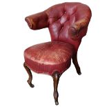 A 19TH CENTURY WALNUT AND RED LEATHER LIBRARY ARMCHAIR Button back upholstery, raised on carved