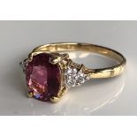 AN 18CT GOLD, OVAL CUT RUBELLITE AND DIAMOND RING.