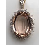A 9CT GOLD, MORGANITE AND DIAMOND PENDANT The large morganite surrounded by diamonds on a chain. (