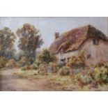 A PAIR OF EARLY 20TH CENTURY WATERCOLOURS View of a thatched house and another by the coast,