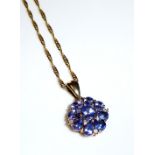 A 9CT GOLD, DIAMOND AND GEM SET DAISY CLUSTER PENDANT AND NECKLACE Set with an arrangement of blue