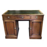 A VICTORIAN MAHOGANY DESK With tooled leather surface above an arrangement of drawers and fitted