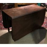 A 19TH CENTURY SOLID MAHOGANY DROP LEAF TABLE With gate leg action, raised on turned legs.