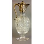 A VICTORIAN SILVER AND CUT CRYSTAL GLASS CLARET JUG The scrolled handle engraved with birds and