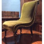 A VICTORIAN EBONIZED AESTHETIC FORM NURSING CHAIR Serpentine shape back and green velvet upholstery,