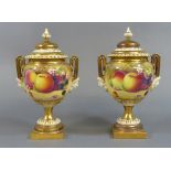 ROYAL WORCESTER, A PAIR OF PORCELAIN COVERED VASES Having twin mask head handles, hand painted