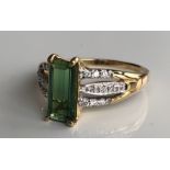 AN 18CT GOLD, TOURMALINE AND DIAMOND RING The baguette cut tourmaline flanked by diamond