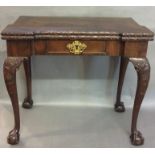 AN 18TH CENTURY MAHOGANY CARD TABLE The fold over breakfront top concealing a velvet baize top