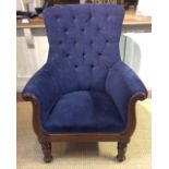 AN EARLY VICTORIAN LIBRARY ARMCHAIR With swept arms and velvet upholstery, raised on turned legs. (w