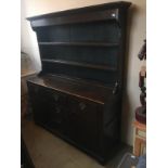 AN EARLY 19TH CENTURY OAK DRESSER With open shelves above an arrangement of drawers and