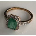 A 9CT GOLD, EMERALD AND DIAMOND RING (size N/O).