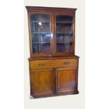 AN EARLY VICTORIAN MAHOGANY SECRÉTAIRE BOOKCASE With stepped cornice, two above arched glazed doors,