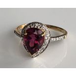 AN 18CT GOLD, PEAR CUT RUBELLITE AND DIAMOND RING (size N).