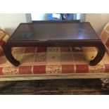 AN ORIENTAL STYLE COFFEE TABLE The top with carved depictions of Chinese Junk ships, raised on